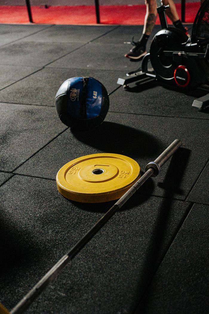 A vibrant gym setup featuring weights and fitness equipment ready for a workout.
